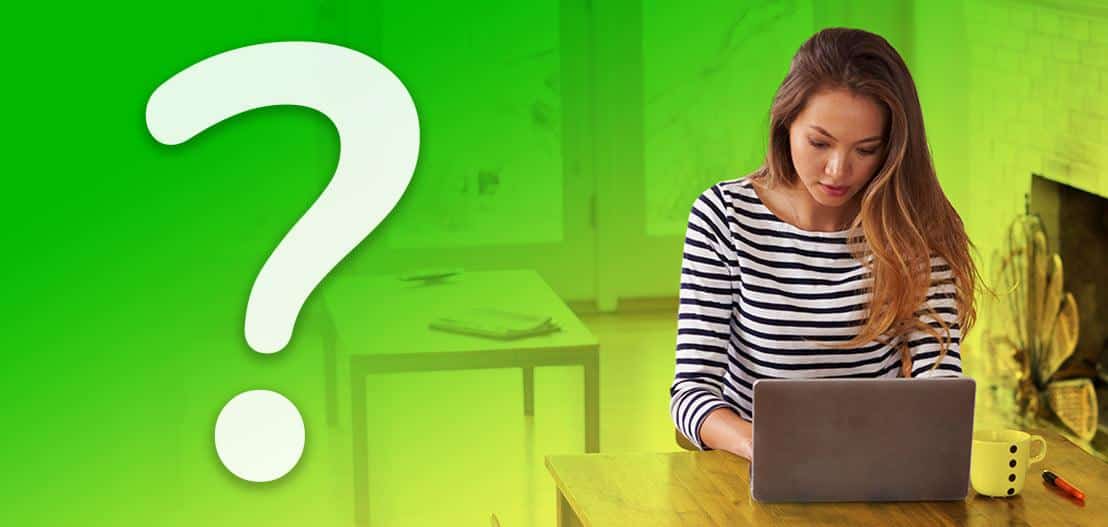 A woman in a striped shirt is using a laptop at a wooden table with a mug nearby. The background has a green gradient with a large white question mark on the left side.