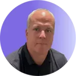 tim-headshot A man with short hair, wearing a dark polo shirt, looks at the camera with a neutral expression. The gradient blue and purple background adds a calm atmosphere suited for effective coaching.