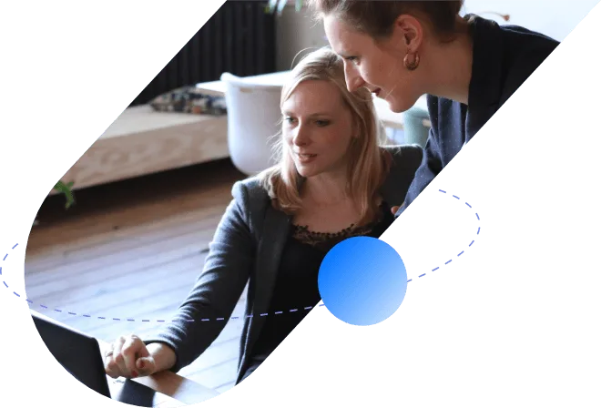 Two colleagues reviewing candidate results together on a laptop