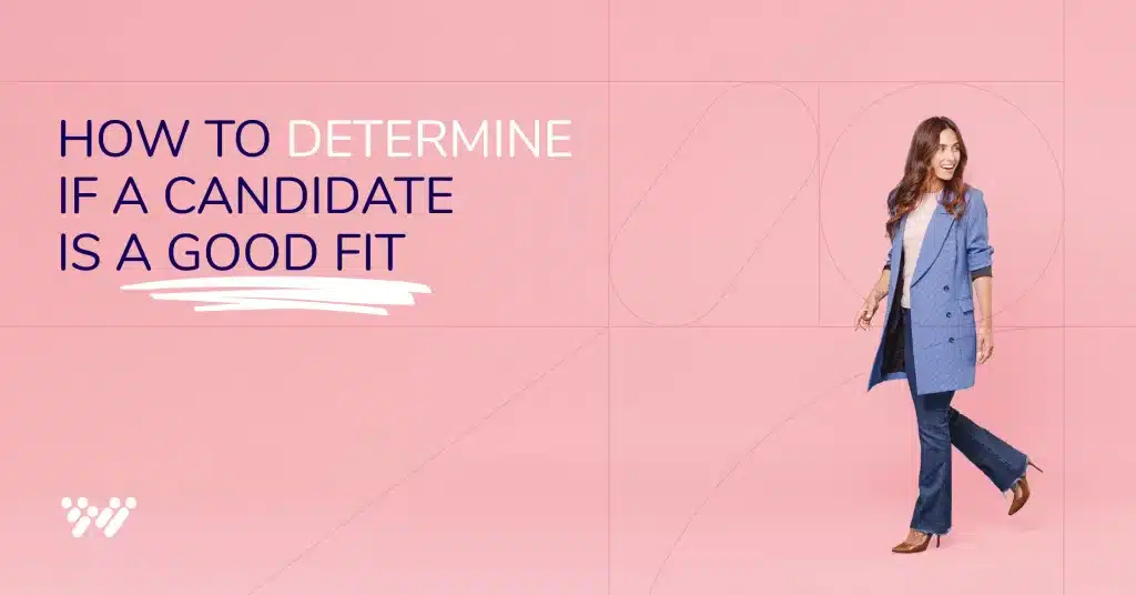 A woman wearing a blue blazer over a white shirt and wide-legged trousers smiles while walking against a pink background. The text on the left reads, "Why is this candidate a good fit for this role?