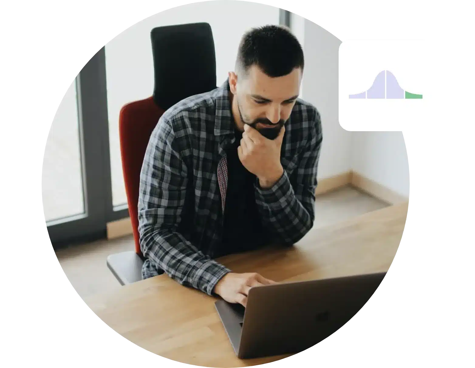 A bearded man in a plaid shirt sits at a wooden desk, focusing intently on a laptop. A graph icon hovers in the top right corner, possibly hinting at his upcoming Wonderlic Test results. Behind him, vertical blinds cover the window, casting subtle shadows across his workspace.